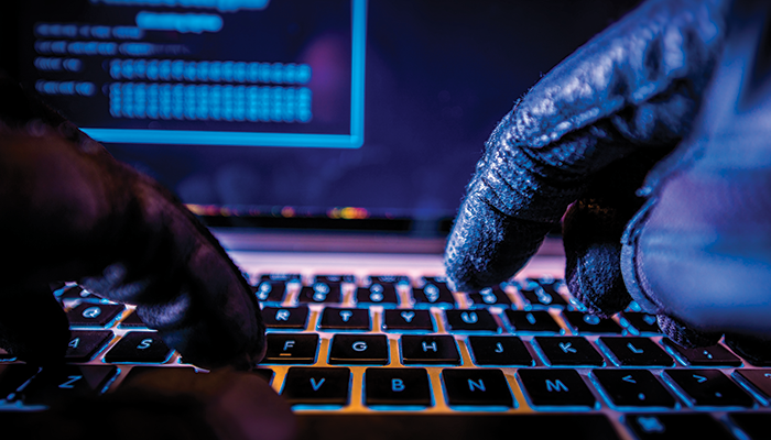 Fraud Hacker on Laptop iStock