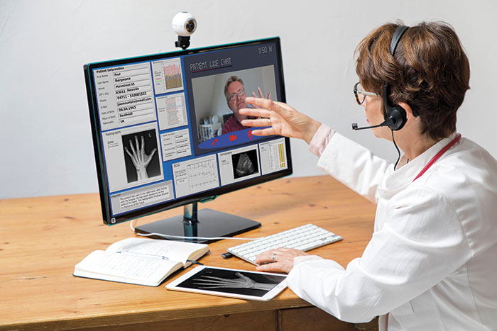 Doctor Communicating with Patient Via Video Calling Alamy