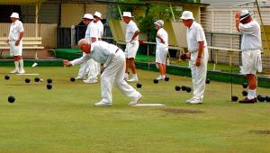 Elderly people playing bowls