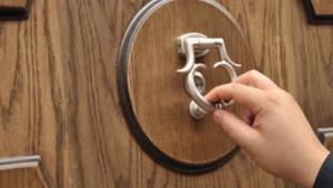 Hand knocking on door, iStock