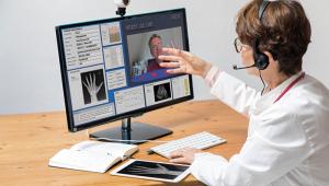 Doctor Communicating with Patient Via Video Calling Alamy