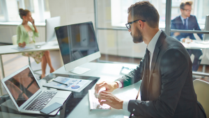 Man working at computer Shutterstock 309941807