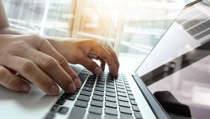 Typing on a laptop