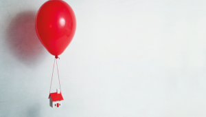house flying tied to a balloon. credit_gettyimages-168894857