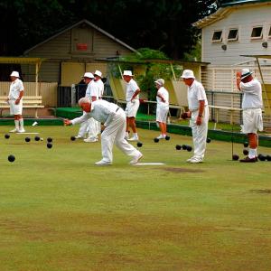 Elderly people playing bowls