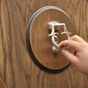 Hand knocking on door, iStock