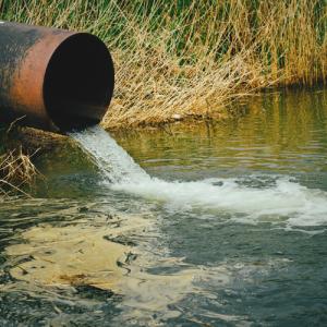 Draining sewage pipe into a river