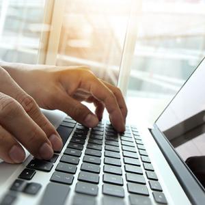Typing on a laptop