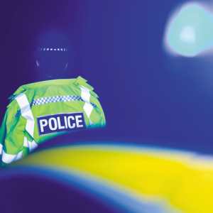 police officer nighttime scene blue emergency.CREDIT_shutterstock_2313089839