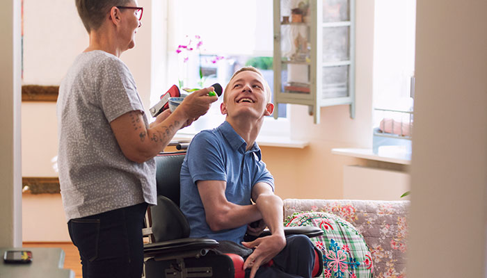 Disabled person with helper ISTOCK Disabled person with helper