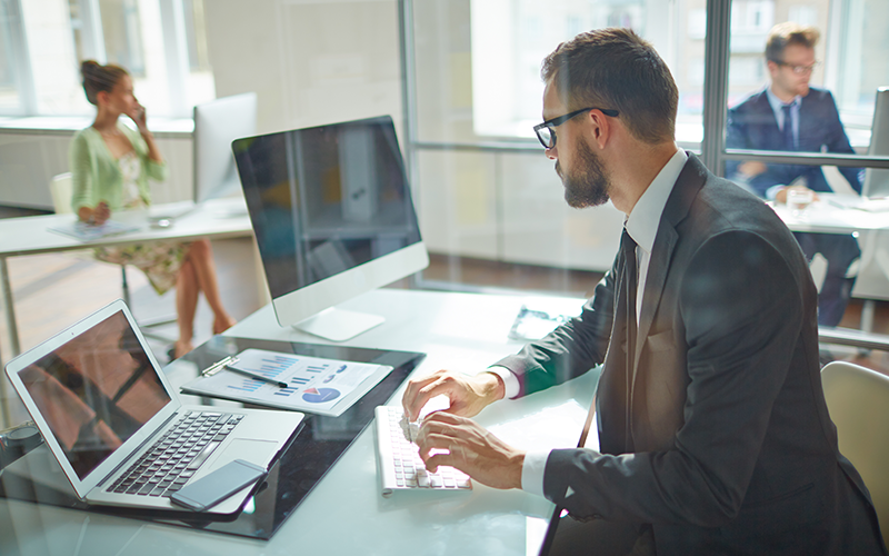 Man working at computer Shutterstock 309941807