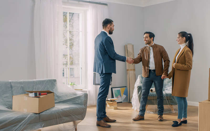 couple-shaking-hands with real estate agent in house. credit_shutterstock_1436511653
