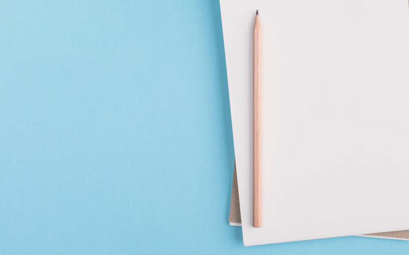 notebook and pencil. CREDIT_shutterstock_1819131380
