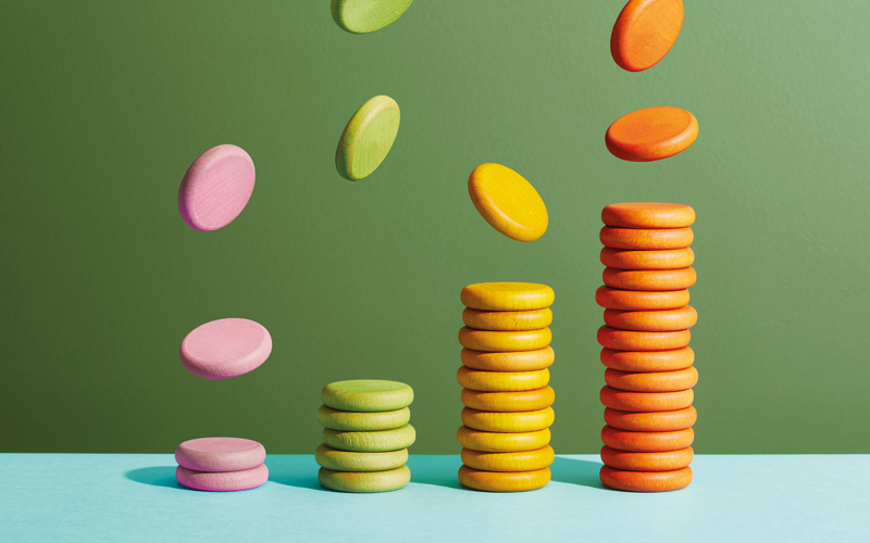 four stacks of coloured coins arranged as a bar.CREDIT_GettyI-1972341398